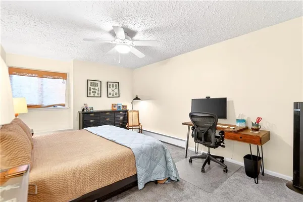 a bedroom with a bed and a desk