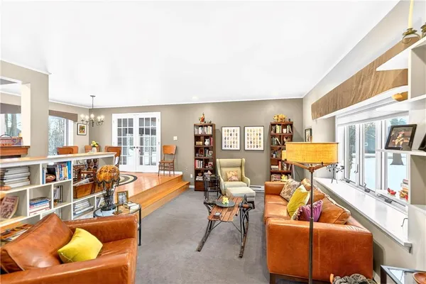 a living room filled with furniture and a book shelf