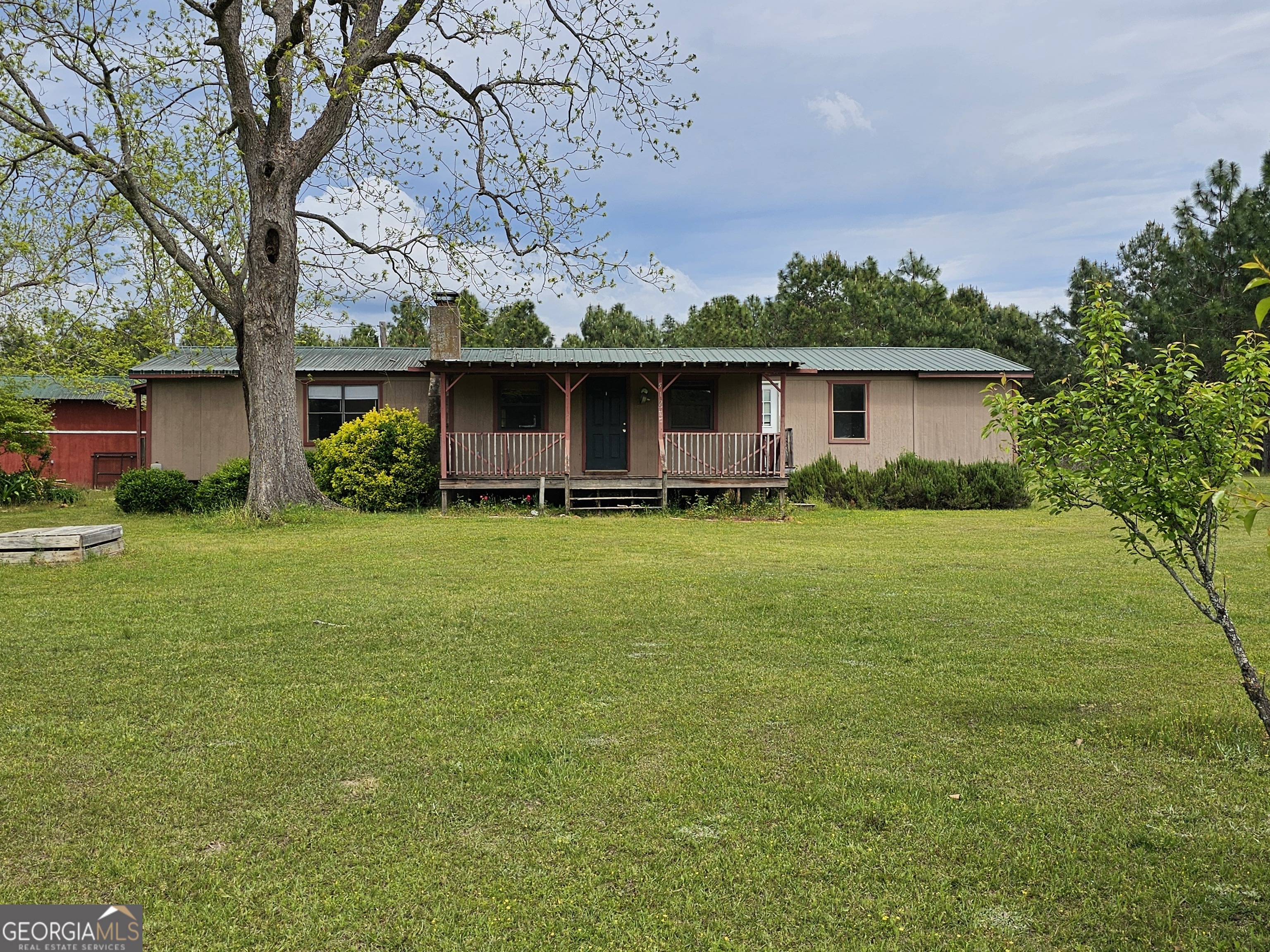 a front view of house with yard and green space