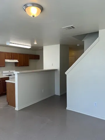 a kitchen with stainless steel appliances a sink stove and cabinets