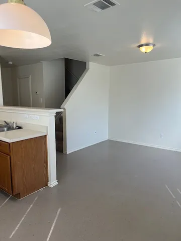 a kitchen with wooden cabinets and a stove top oven
