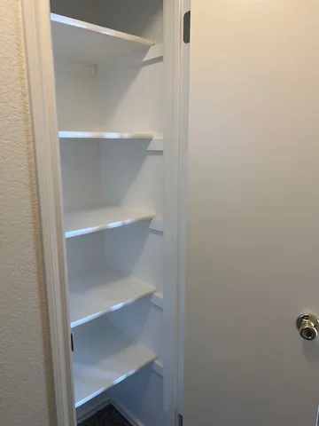 an empty room with windows and closet