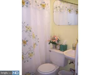 100 Edison Road Cherry Hill, NJ 08034 - Photo 3 of 5 a white toilet sitting next to a bathroom sink