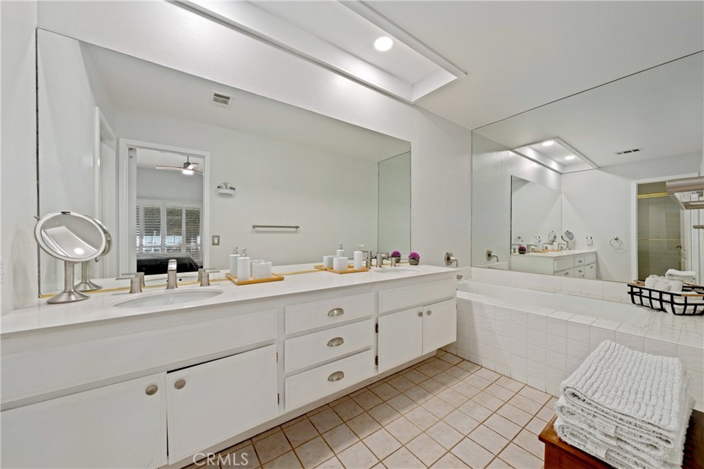 46 Pebble Beach Drive Rancho Mirage, CA 92270 - Photo 18 of 29 a spacious bathroom with a granite countertop sink mirror and bathtub