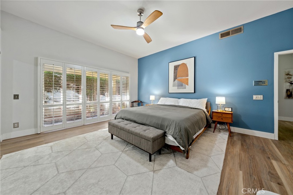 46 Pebble Beach Drive Rancho Mirage, CA 92270 - Photo 20 of 29 a spacious bedroom with a bed a dresser and a large window