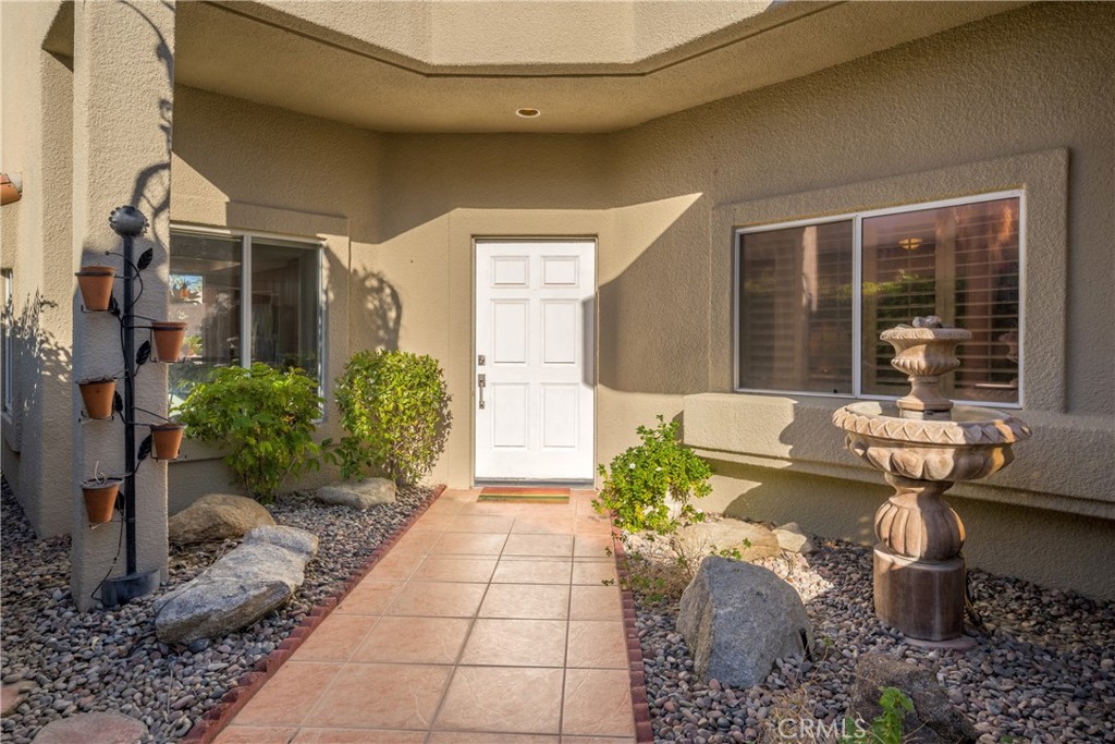 46 Pebble Beach Drive Rancho Mirage, CA 92270 - Photo 23 of 29 a front view of a house with garden