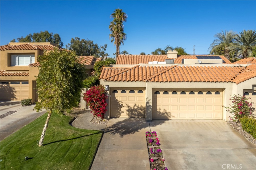 46 Pebble Beach Drive Rancho Mirage, CA 92270 - Photo 25 of 29 a front view of a house with a garden