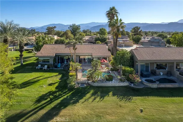 a view of house with swimming pool outdoor seating