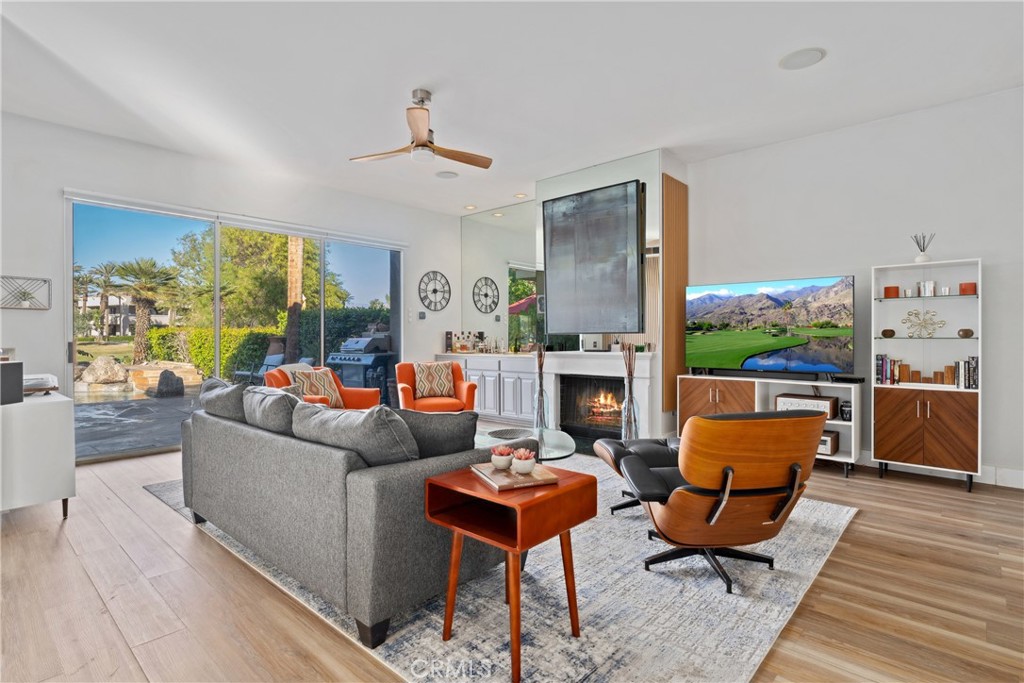 46 Pebble Beach Drive Rancho Mirage, CA 92270 - Photo 6 of 29 a living room with furniture a fireplace and a large window