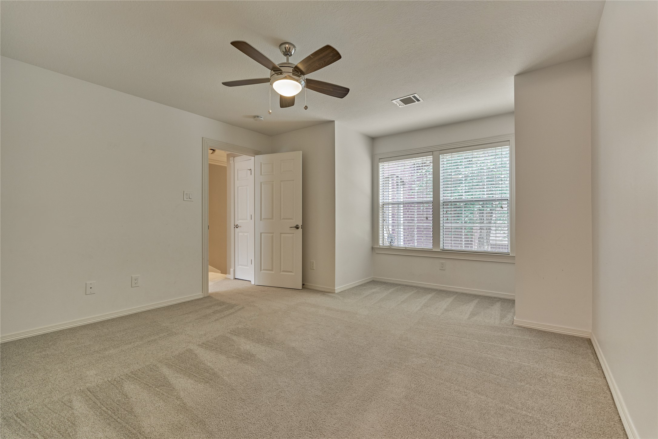 7 Gentry Oak Court Spring, TX 77381 - Photo 35 of 50 an empty room with chandelier fan and windows