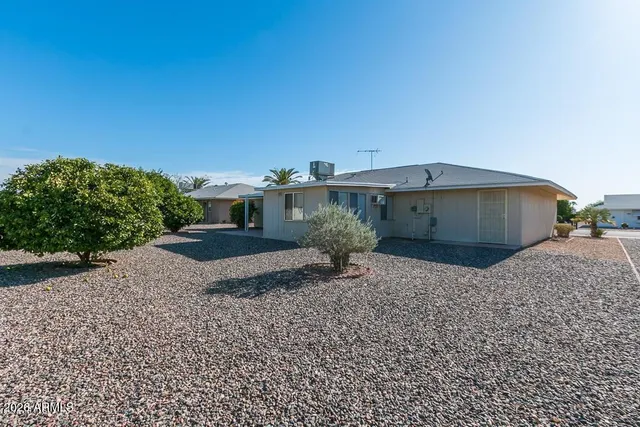 a view of a house with a yard and tree s