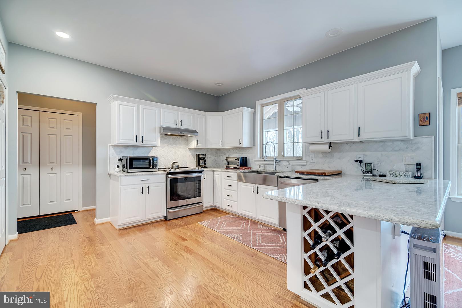 2 Michigan State Drive Newark, DE 19713 - Photo 15 of 65 a kitchen with granite countertop white cabinets and white appliances
