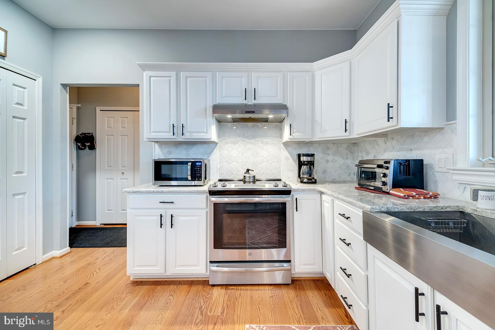 2 Michigan State Drive Newark, DE 19713 - Photo 17 of 65 a kitchen with stainless steel appliances granite countertop a stove and white cabinets