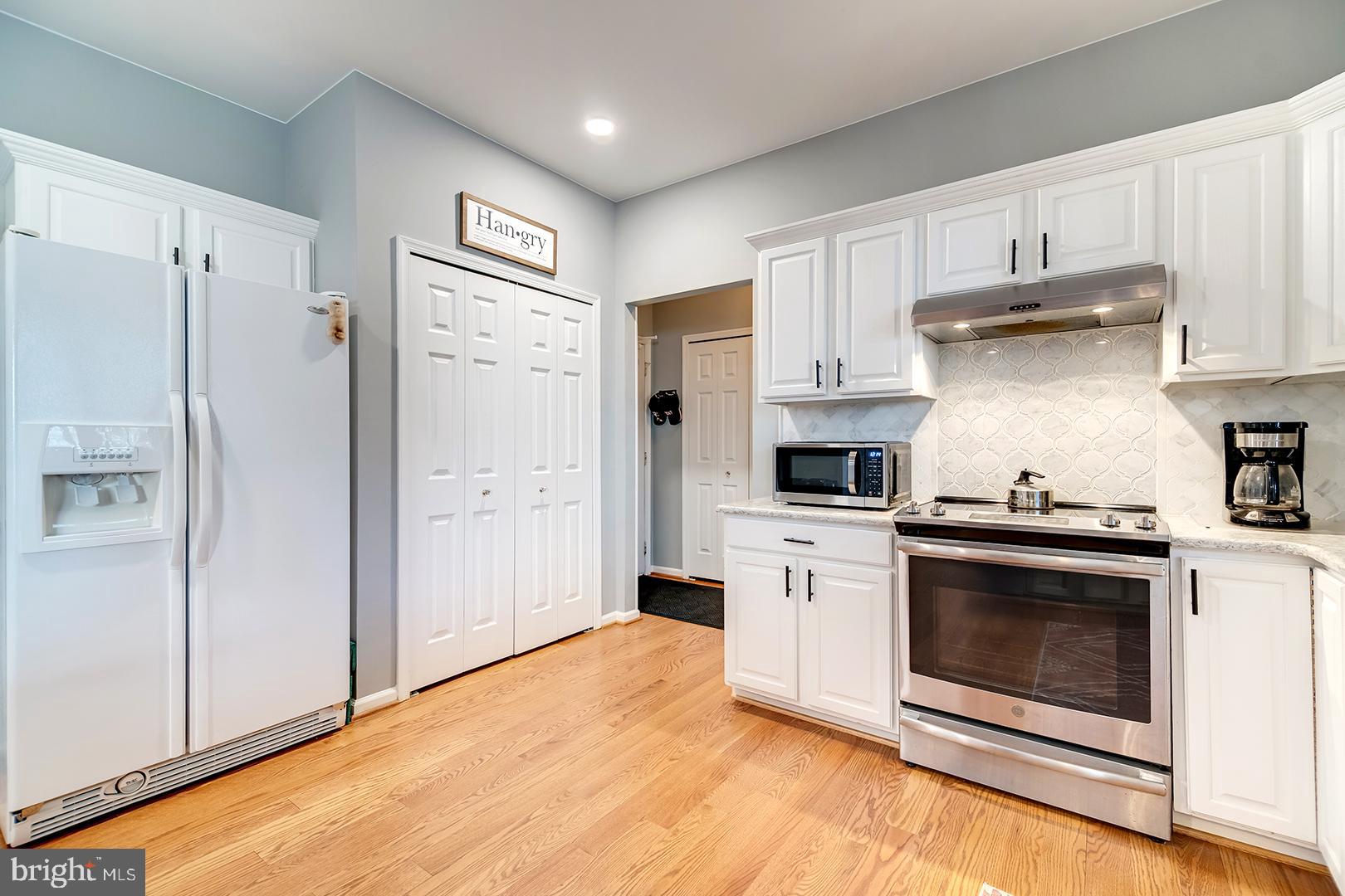 2 Michigan State Drive Newark, DE 19713 - Photo 18 of 65 a kitchen with stainless steel appliances white cabinets and wooden floors