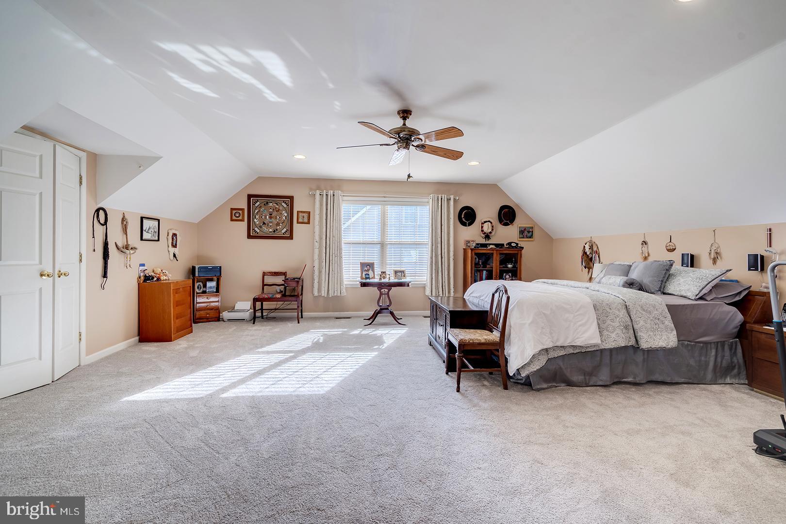 2 Michigan State Drive Newark, DE 19713 - Photo 41 of 65 a spacious bedroom with a bed a couch and a chandelier