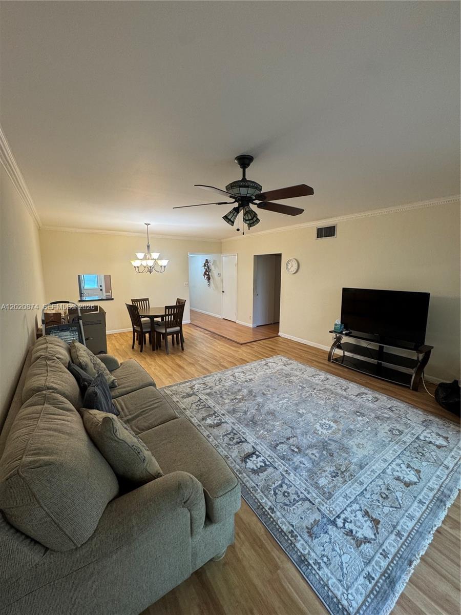 6731 Cypress Road, Unit 410 Plantation, FL 33317 - Photo 8 of 15 a living room with furniture and a flat screen tv