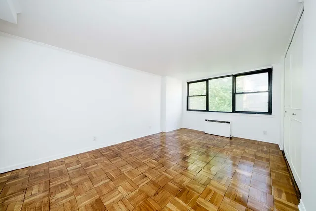 a bedroom with bed couch and window