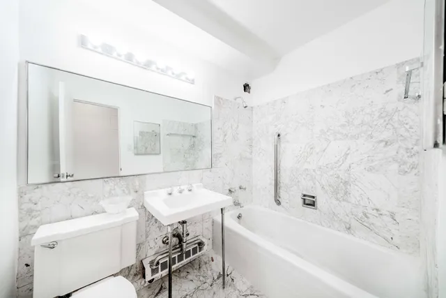 a kitchen with stainless steel appliances a sink a stove and cabinets