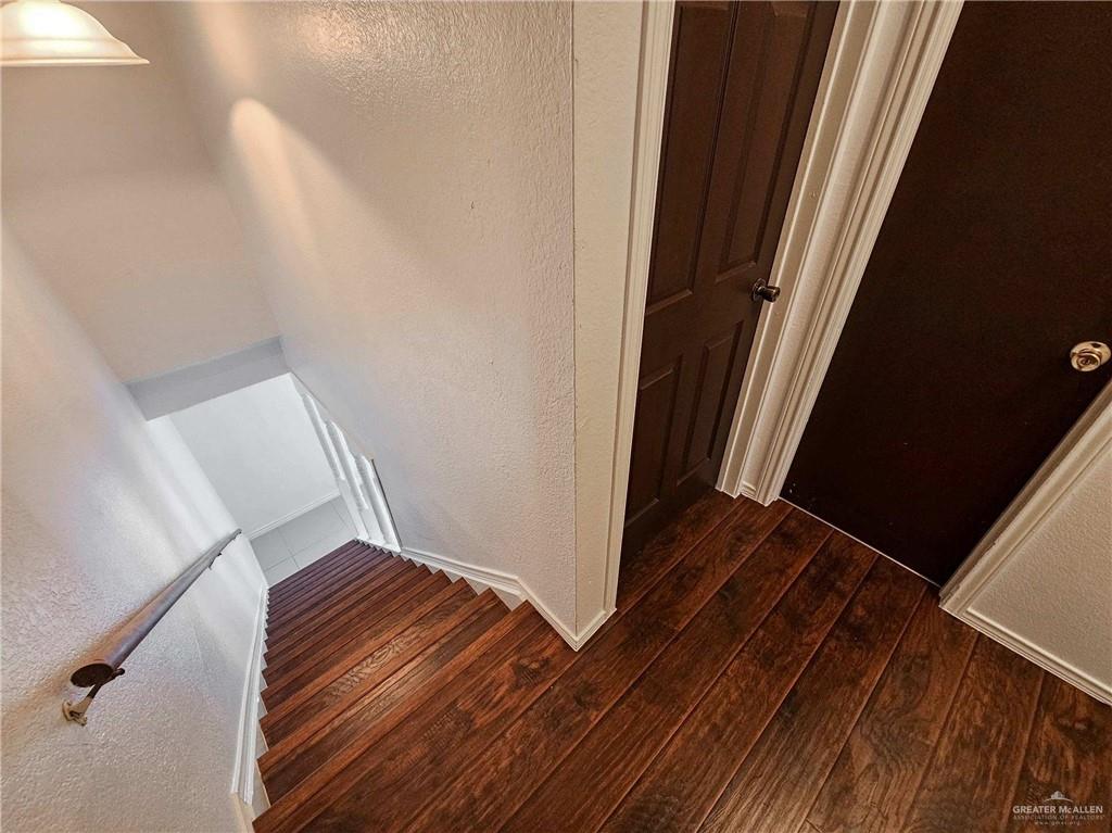 2201 South Jackson Road, Unit 2I Pharr, TX 78577 - Photo 10 of 23 Rich wood-finish flooring extending from the landing to the staircase