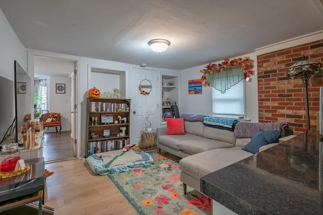 a living room with furniture and a book shelf