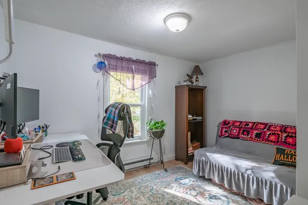 a bedroom with a bed and a couch