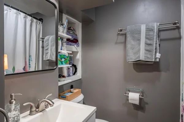 a bathroom with a sink toilet and shower