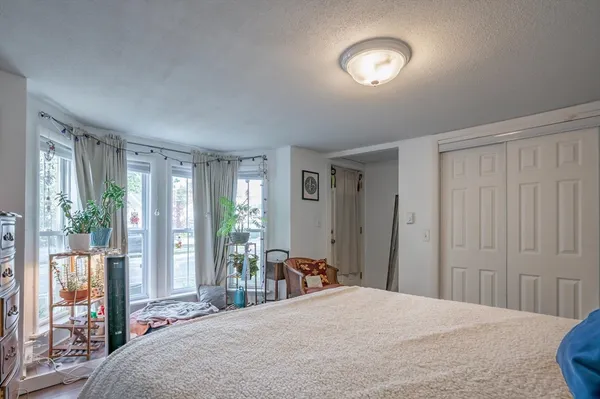 a bedroom with a bed and a lamp with window