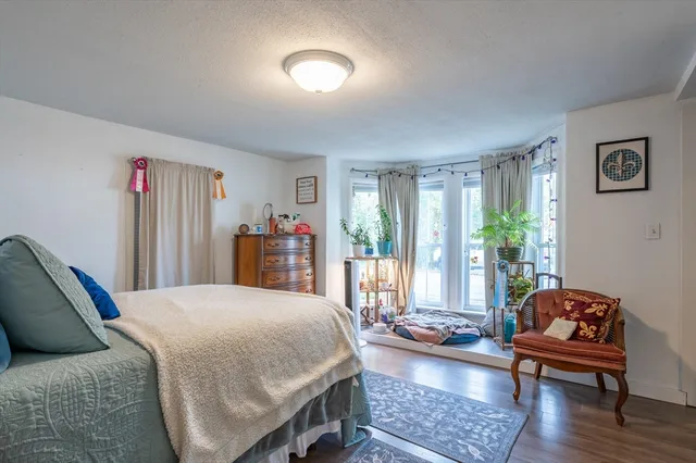 a bedroom with a bed and a couch