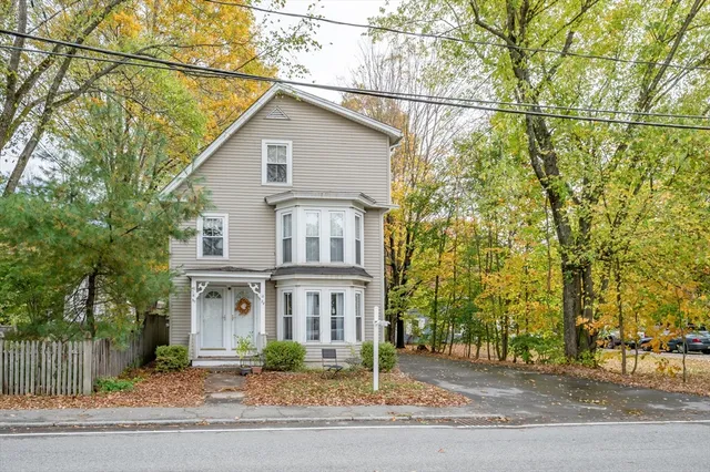 a view of a house with a yard and garage