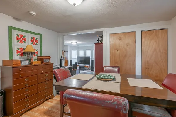 a room with a desk and chair with wooden floor