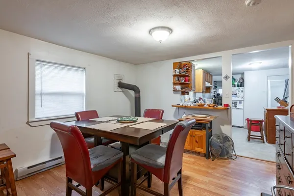 a view of a dining room with furniture and wooden floor
