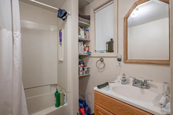 a bathroom with a sink vanity and a mirror