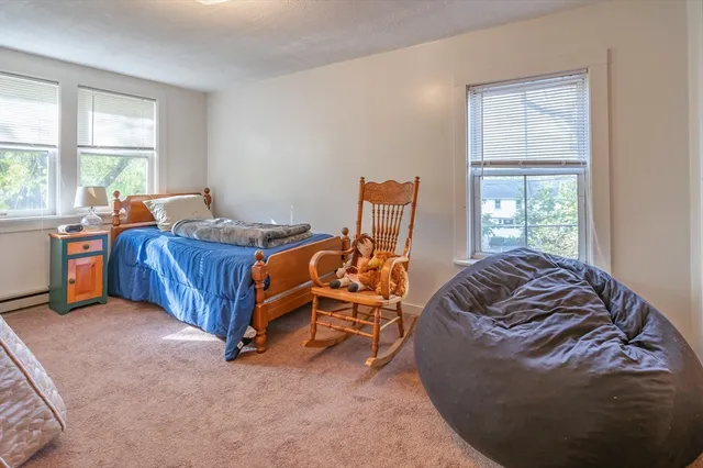 a bed sitting in a bedroom next to a window