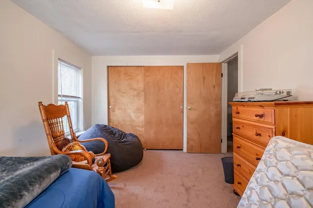 a bedroom with furniture and a window