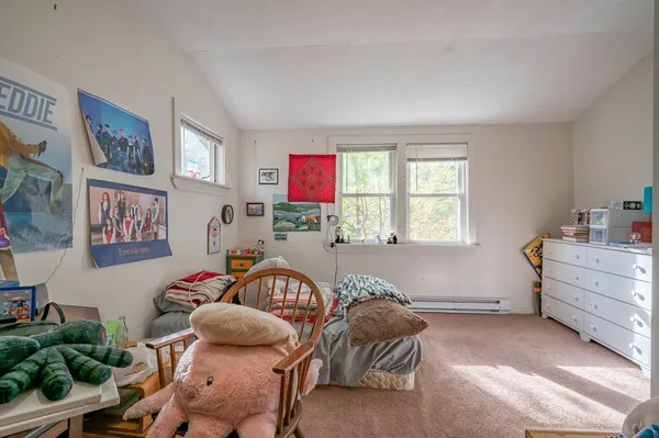 a bedroom with furniture and a window