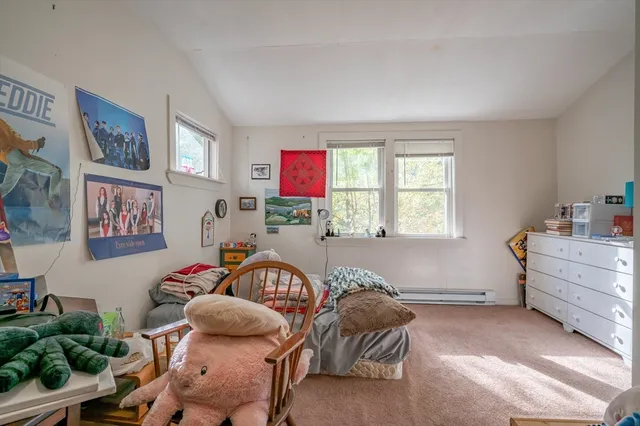 a bedroom with furniture and a window