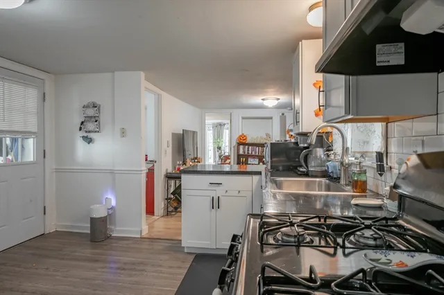 a kitchen with a sink and a stove top oven