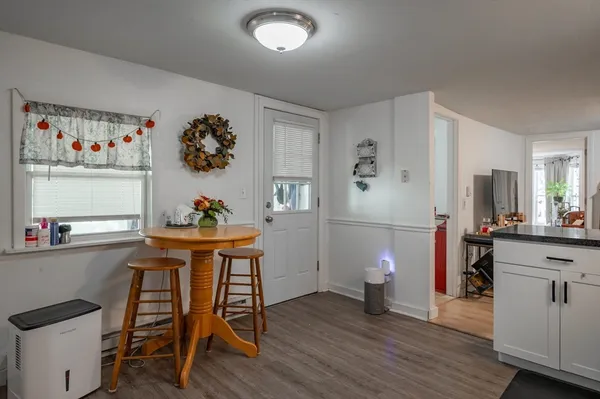 a dining room with a wooden table and chairs