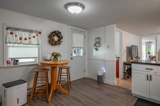 a dining room with a wooden table and chairs