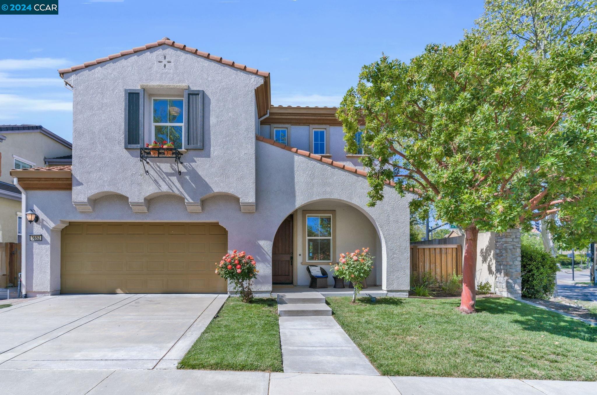 a front view of a house with garden