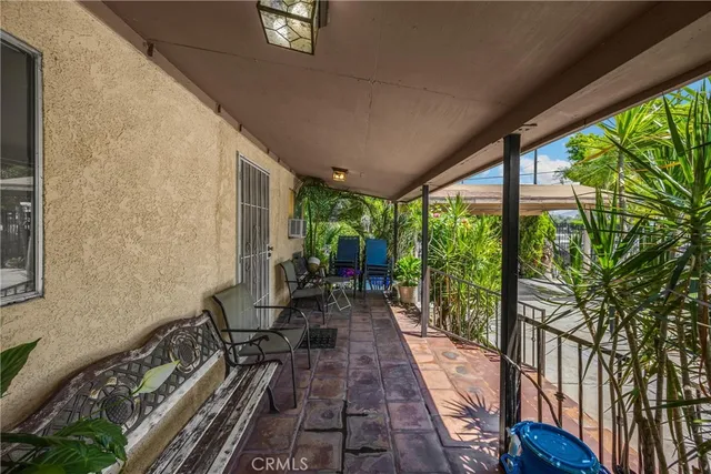 a living room with furniture ceiling fan and a window