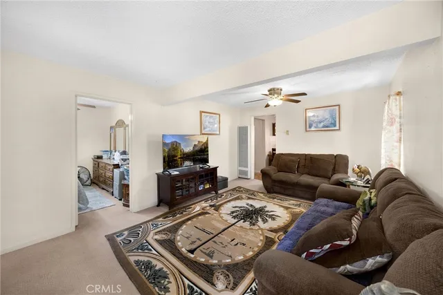 a living room with furniture a couch and a flat screen tv