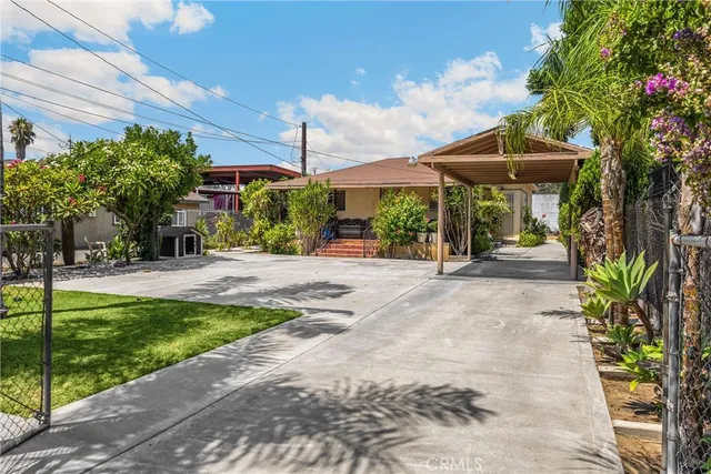 a view of a street with potted plants