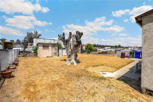 a view of a patio with table and chairs under an umbrella