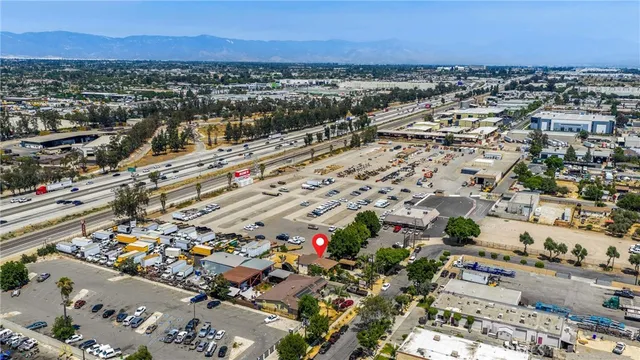 a view of a backyard with a table and chairs under an umbrella