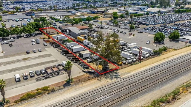 a view of a patio with table and chairs under an umbrella