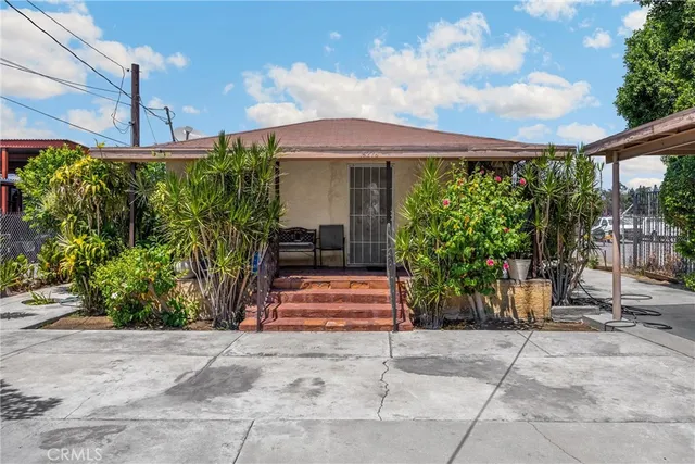 a patio with a table and chairs under an umbrella