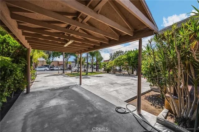 a view of a patio with a table and chairs under an umbrella
