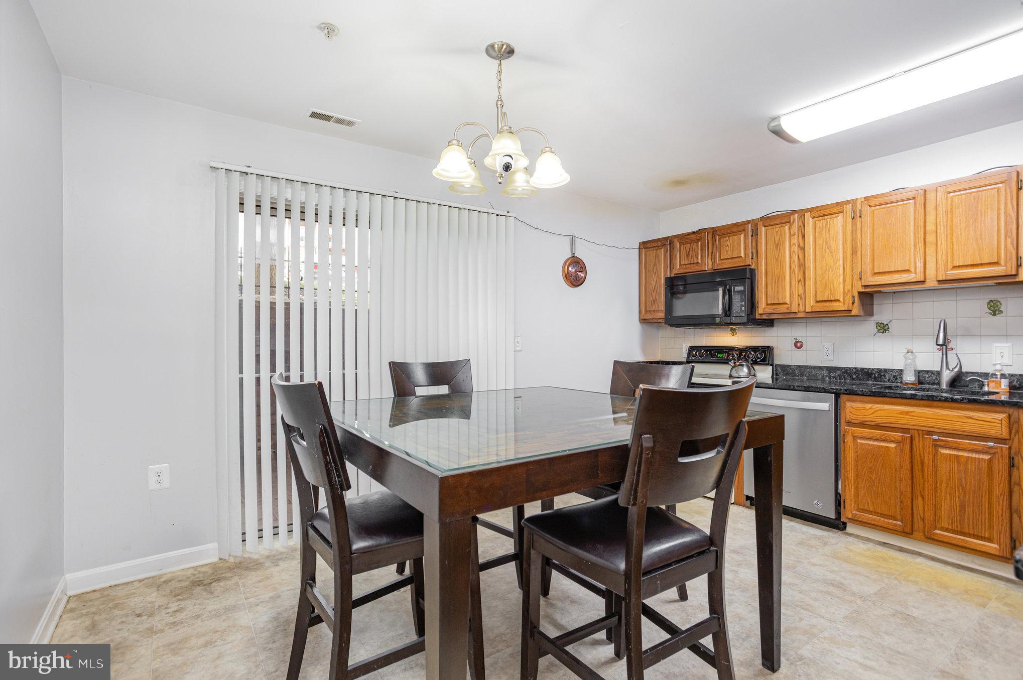 3905 Darleigh Road, Unit F Nottingham, MD 21236 - Photo 11 of 33 a view of a dining room with furniture and a kitchen
