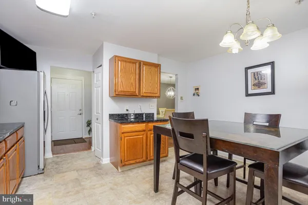 a view of a dining room with furniture and a chandelier